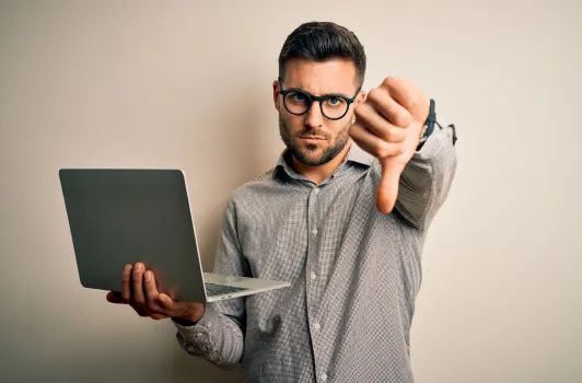 man holding laptop showing thumbs down